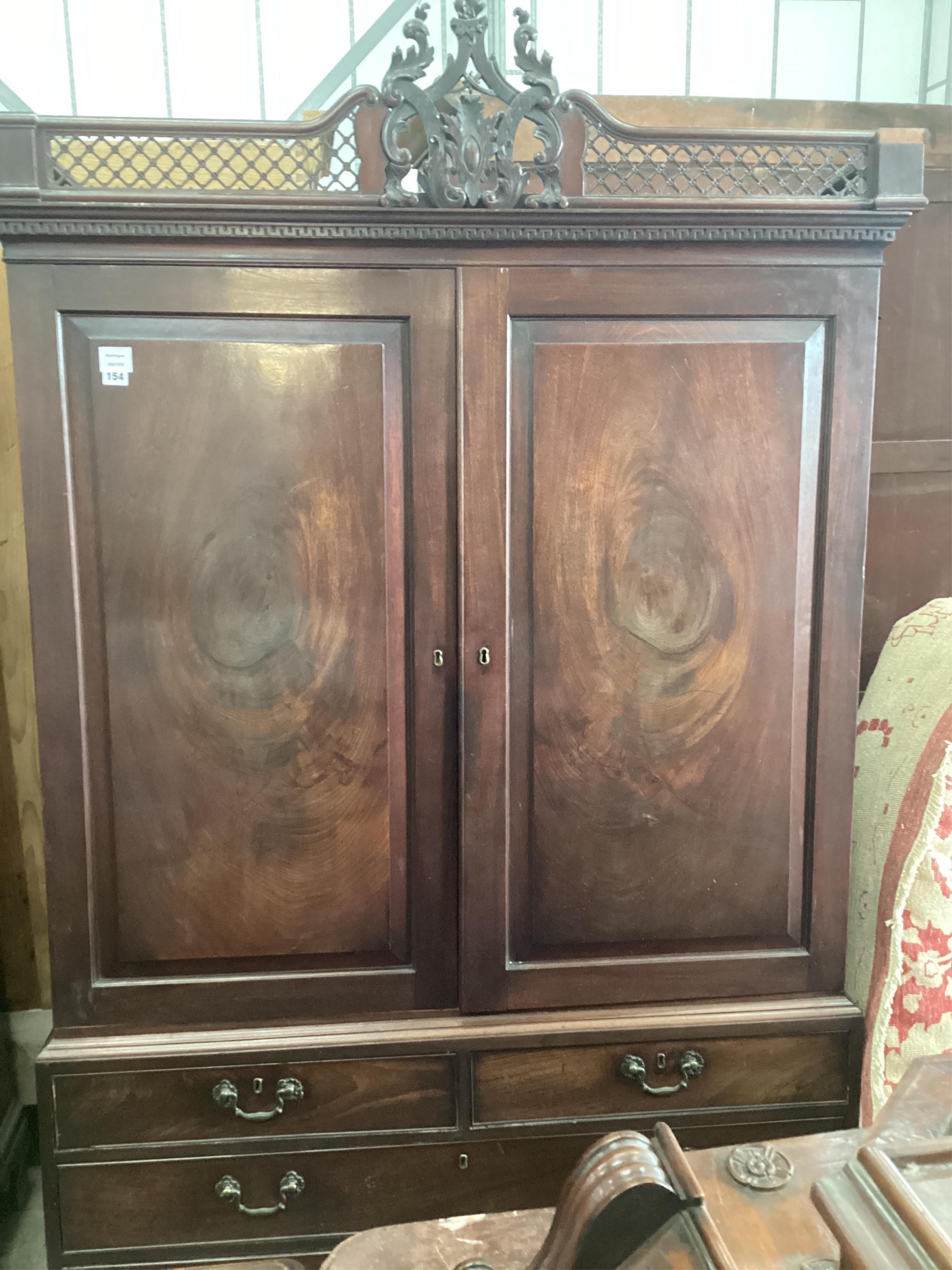 A George III Cuban mahogany linen press, lacking trays, converted to a hanging wardrobe, width 124cm, depth 60cm, height 210cm
